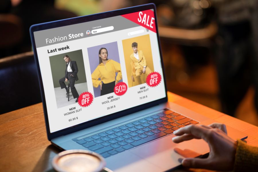 image of shopper looking at laptop screen to find for sale items