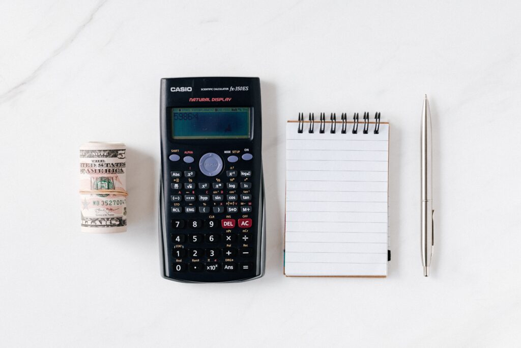 calculator and notepad shown as tool for passive income generation