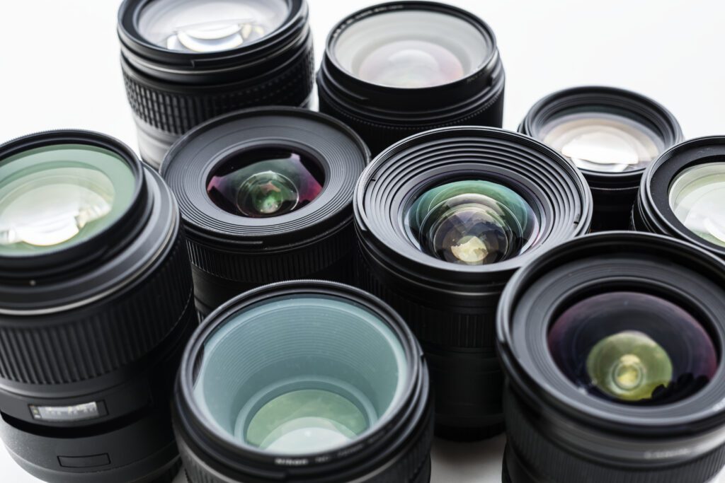 Several camera lenses stacked next to each other
